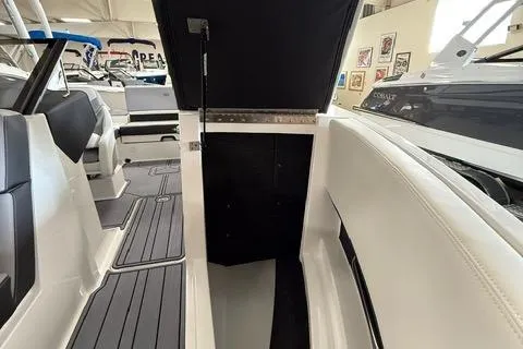 Slide: The Image of 2025 Cobalt CS22 boat interior with open storage compartment, featuring sleek seating and modern design. - 10