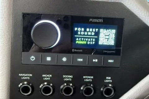 Slide: The Image of Control panel of 2025 Cobalt CS22 boat with Fusion audio system and light switches. - 15