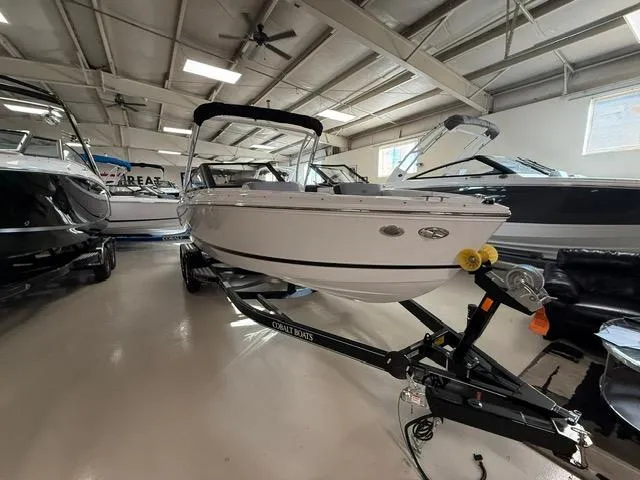 Slide: The Image of 2025 Cobalt CS22 boat displayed in a showroom, on a trailer, under bright lighting. - 3