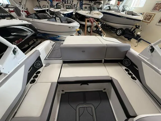 Slide: The Image of 2025 Cobalt CS22 boat interior with spacious seating in a showroom. - 6