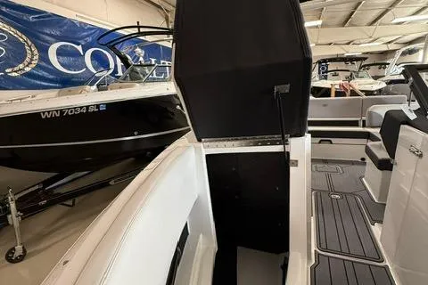 Slide: The Image of 2025 Cobalt CS22 boat interior with open storage compartment in showroom. - 9