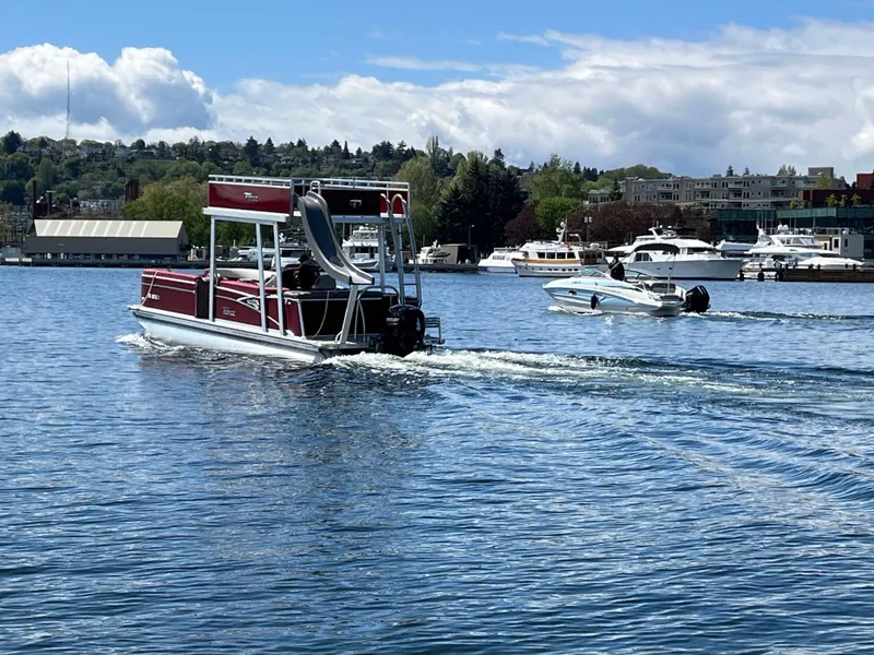 Slide: The Image of 2023 Tahoe Pontoon Cascade Cruise Funship on a scenic lake with other boats. - 14