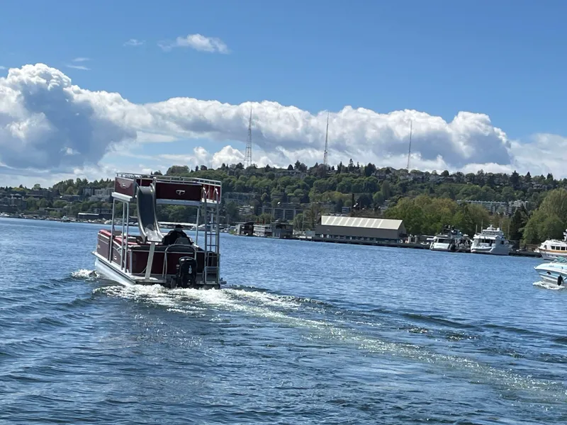 Slide: The Image of 2023 Tahoe Pontoon Cascade Cruise Funship on a scenic lake under a blue sky. - 16
