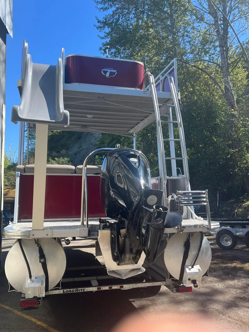 Slide: The Image of 2023 Tahoe Pontoon Cascade Cruise Funship with slide and outboard motor, parked outdoors. - 18