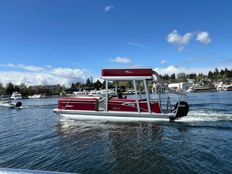 Slide: The Image of 2023 Tahoe Pontoon Cascade Cruise Funship on a sunny lake, showcasing its vibrant red design. - 4