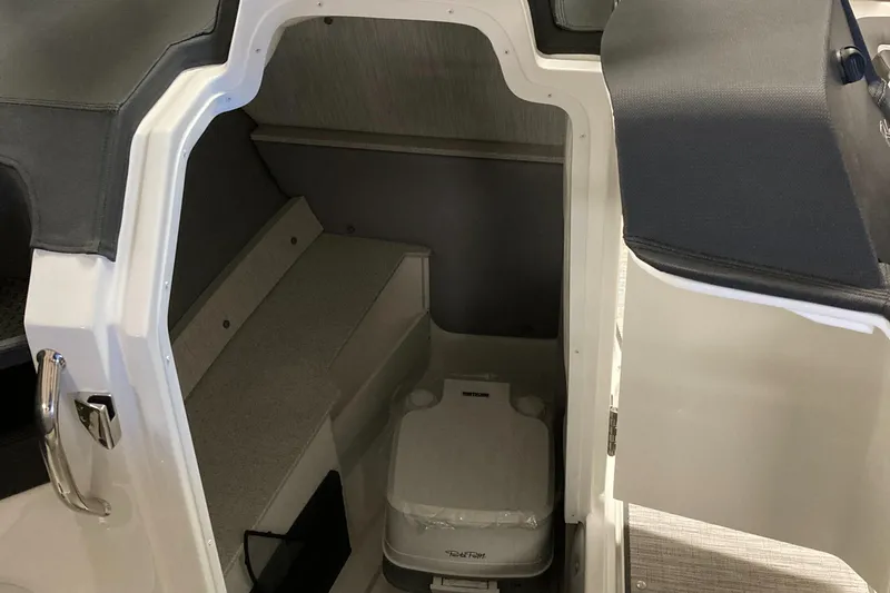 Slide: The Image of 2025 Cobalt R6 boat interior with compact cabin and portable toilet. - 13