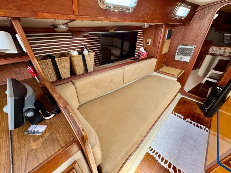 Slide: The Image of Interior of 1979 Irwin Citation 39 sailboat with cozy seating and wooden accents. - 13