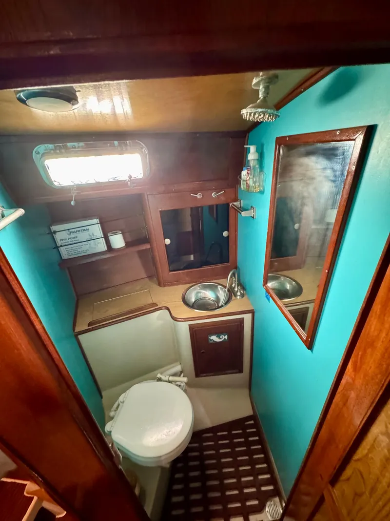 Slide: The Image of 1979 Irwin Citation 39 yacht bathroom with sink, toilet, and mirror. - 14