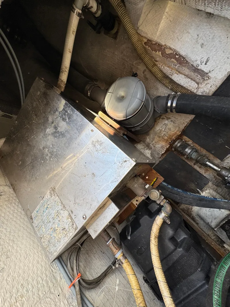 Slide: The Image of Engine compartment of a 1979 Irwin Citation 39 sailboat, showing mechanical components and hoses. - 23