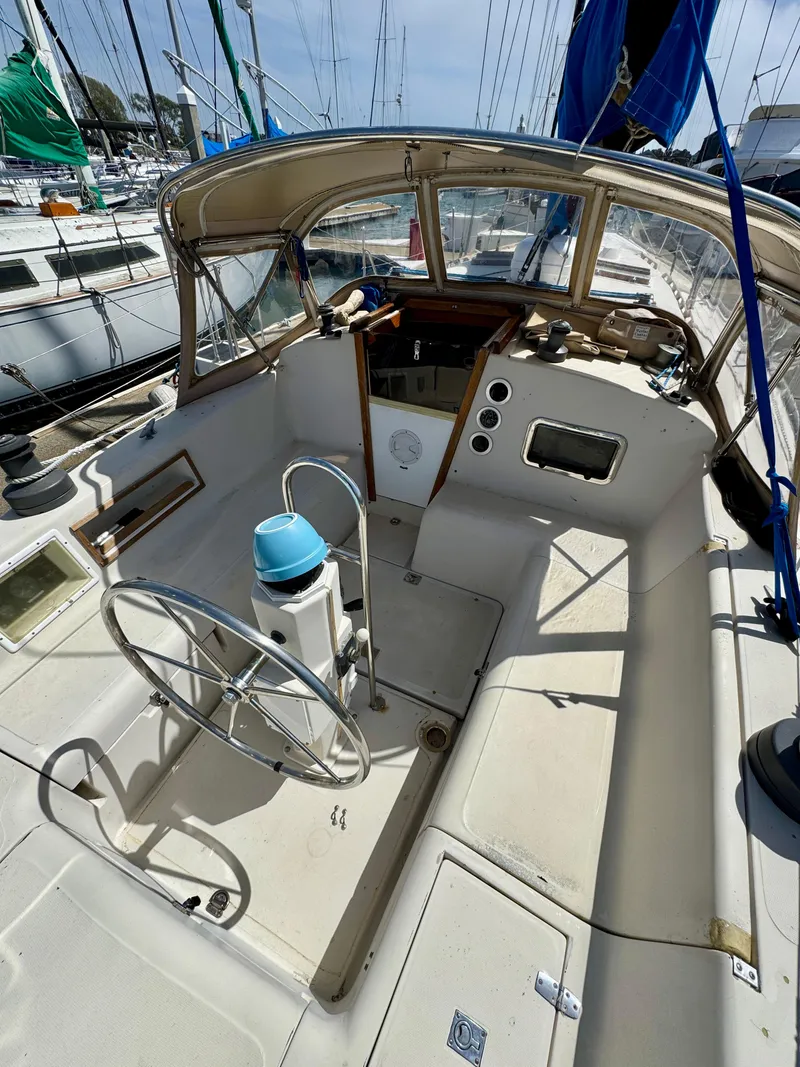 Slide: The Image of 1979 Irwin Citation 39 sailboat cockpit with steering wheel and navigation instruments. - 5