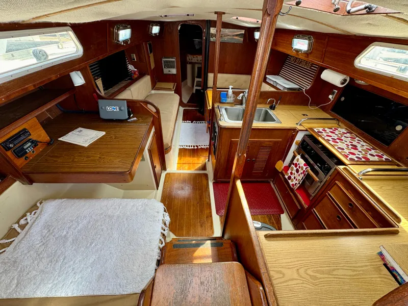 Slide: The Image of Interior of 1979 Irwin Citation 39 sailboat with wood finish and compact kitchen area. - 8