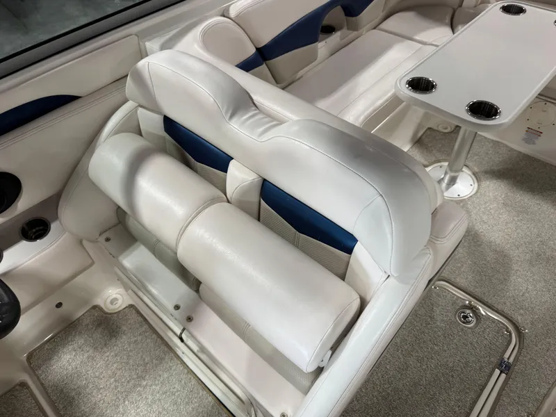 Slide: The Image of 2009 Chaparral 276 SSX boat interior with white seating and table. - 10