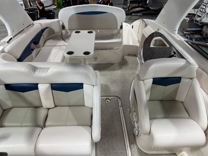 Slide: The Image of 2009 Chaparral 276 SSX boat interior with white seating and table. - 12