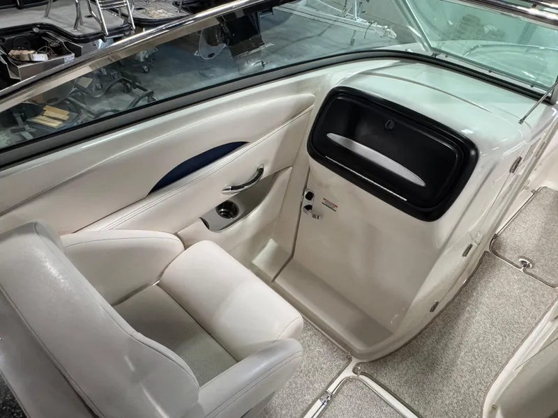 Slide: The Image of 2009 Chaparral 276 SSX boat interior with white seating and sleek dashboard design. - 13