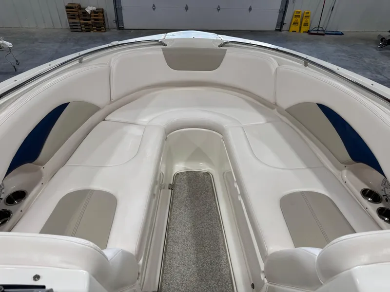 Slide: The Image of 2009 Chaparral 276 SSX boat interior with white seating and carpeted floor. - 15