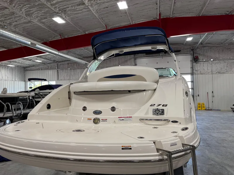 Slide: The Image of 2009 Chaparral 276 SSX boat in indoor showroom, rear view with swim platform. - 6