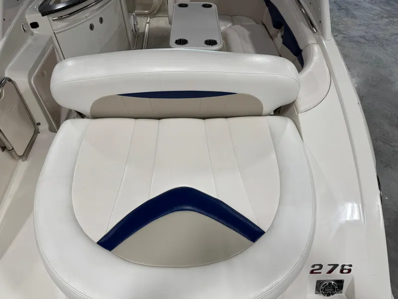 Slide: The Image of 2009 Chaparral 276 SSX boat interior with white and blue seating. - 8