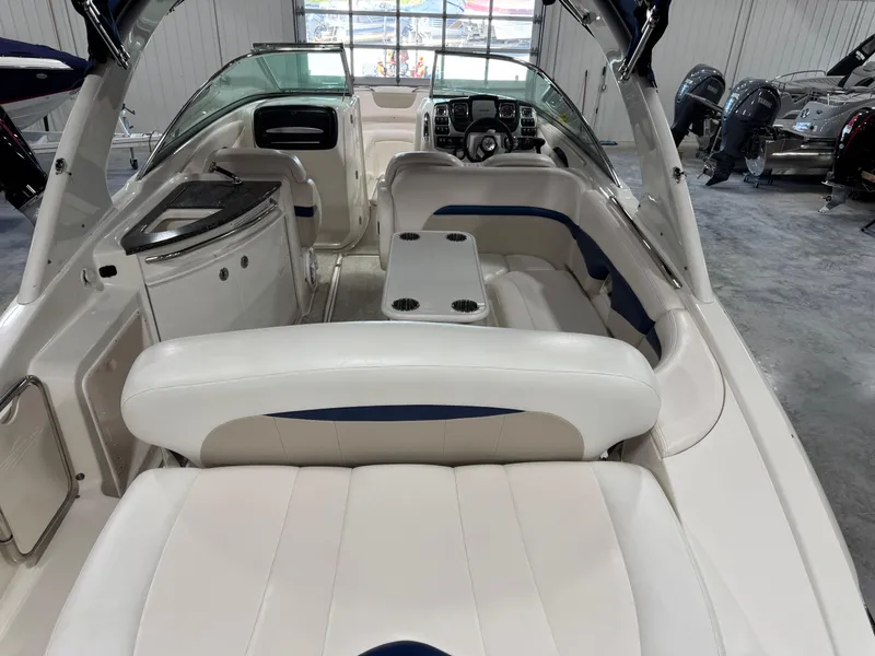 Slide: The Image of 2009 Chaparral 276 SSX boat interior with white seating and modern dashboard. - 9
