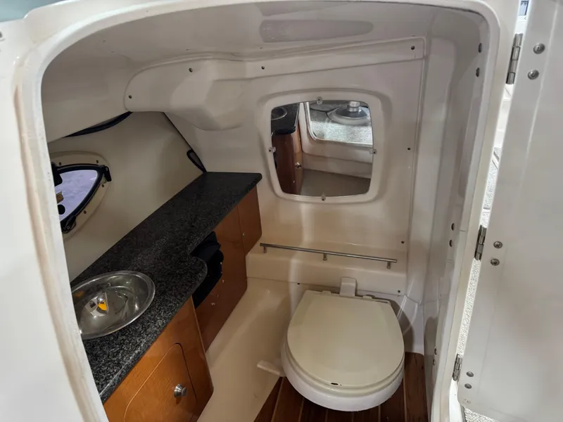 Slide: The Image of 2008 Chaparral Sunesta 284 boat interior with compact bathroom and sink. - 11