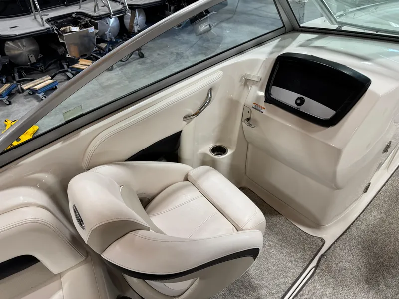 Slide: The Image of 2008 Chaparral Sunesta 284 boat interior with white seating and dashboard. - 12