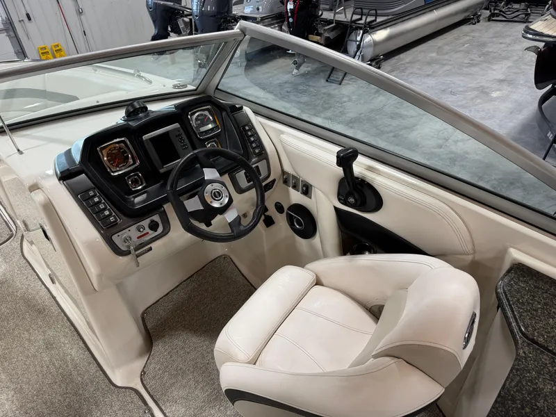 Slide: The Image of 2008 Chaparral Sunesta 284 boat cockpit with steering wheel and control panel. - 13