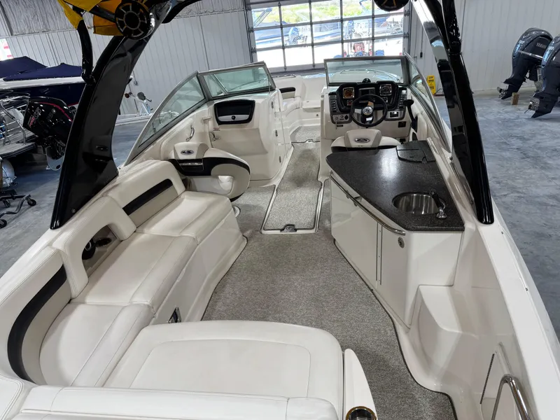 Slide: The Image of 2008 Chaparral Sunesta 284 boat interior with white seating and modern dashboard. - 14
