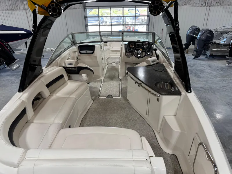 Slide: The Image of 2008 Chaparral Sunesta 284 boat interior with white seating and modern dashboard. - 5