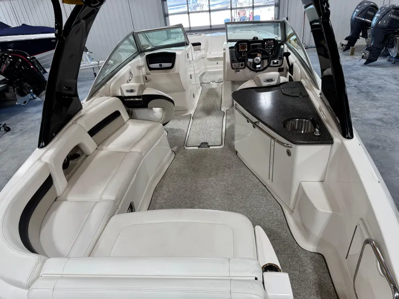 Slide: The Image of 2008 Chaparral Sunesta 284 boat interior with white seating and sleek dashboard. - 6