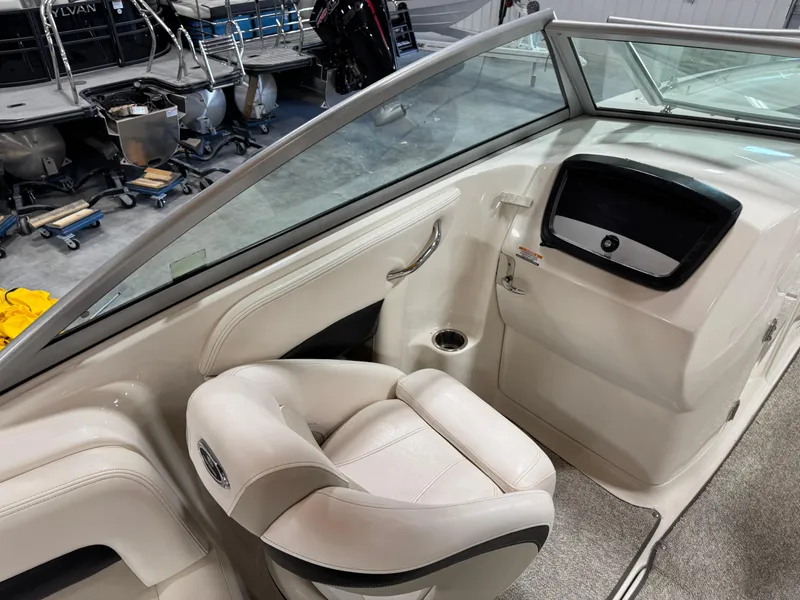 Slide: The Image of 2008 Chaparral Sunesta 284 boat interior with white seating and dashboard. - 9
