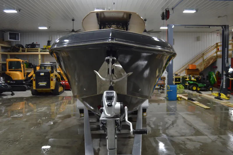 Slide: The Image of 2017 Statement 380 Open boat in a garage with various equipment. - 21