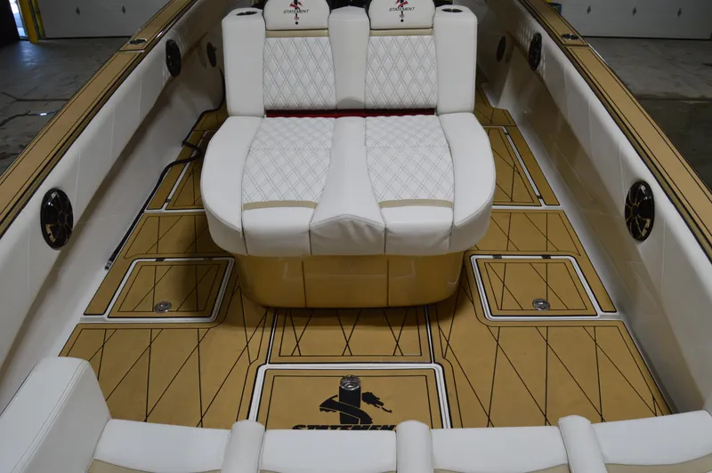 Slide: The Image of 2017 Statement 380 Open boat interior with white seating and tan flooring. - 22