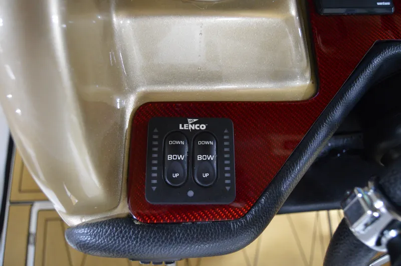 Slide: The Image of Lenco trim tab control panel on 2017 Statement 380 Open boat dashboard. - 43