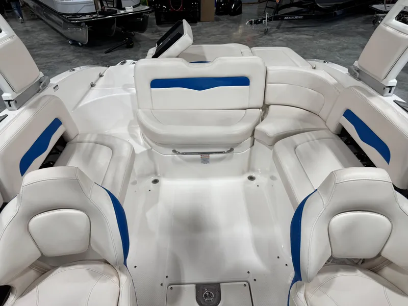 Slide: The Image of 2018 Chaparral 246 SSi Surf boat interior with white and blue seating. - 10