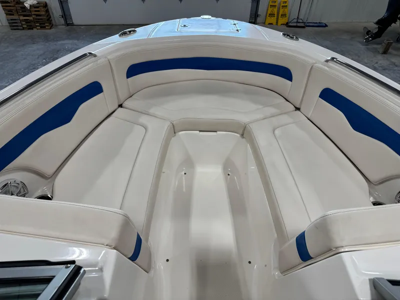Slide: The Image of 2018 Chaparral 246 SSi Surf boat interior with white and blue seating. - 11