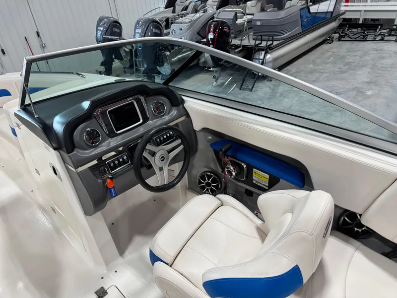 Slide: The Image of 2018 Chaparral 246 SSi Surf boat interior with steering wheel and dashboard controls. - 13