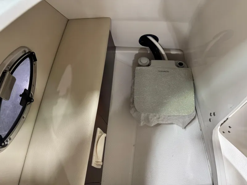 Slide: The Image of 2018 Chaparral 246 SSi Surf boat interior with seating and storage compartment. - 15