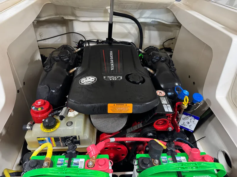 Slide: The Image of Engine compartment of a 2018 Chaparral 246 SSi Surf boat, featuring Volvo Penta components. - 17
