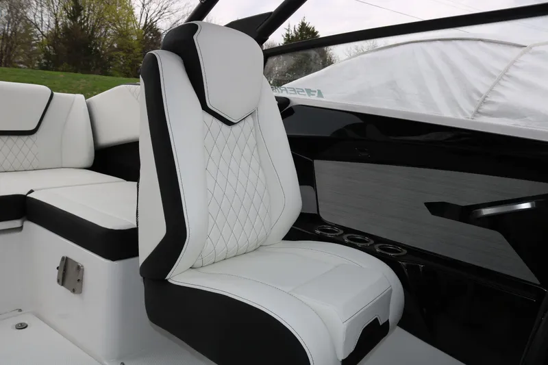 Slide: The Image of 2025 Yamaha Boats 222SE interior with luxurious white and black seating. - 10