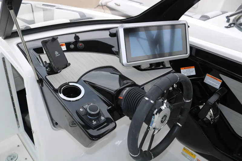 Slide: The Image of 2025 Yamaha Boats 222SE dashboard with touchscreen, steering wheel, and control panel. - 12