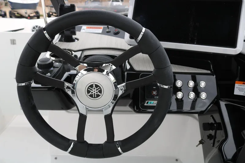 Slide: The Image of Steering wheel of 2025 Yamaha Boats 222SE, featuring modern controls and dashboard. - 13
