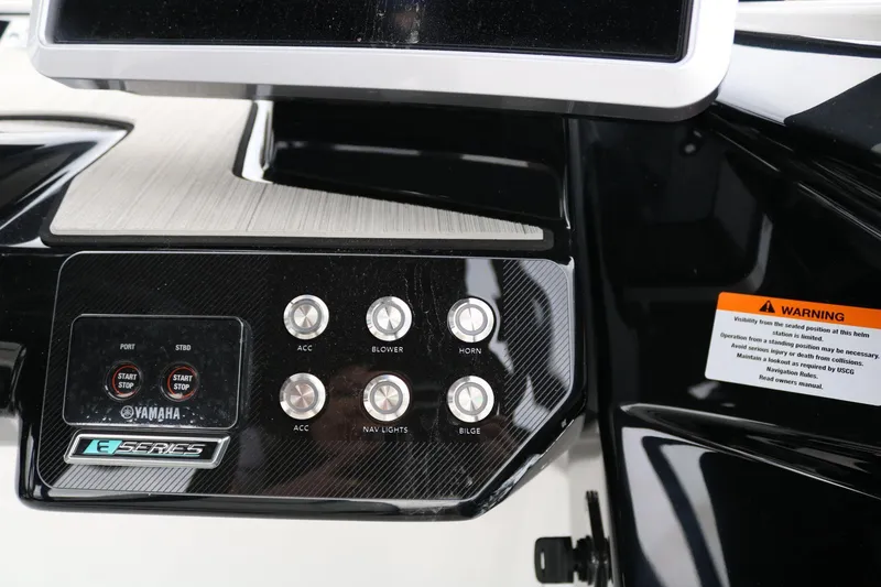 Slide: The Image of Control panel of 2025 Yamaha Boats 222SE with buttons and warning label. - 14