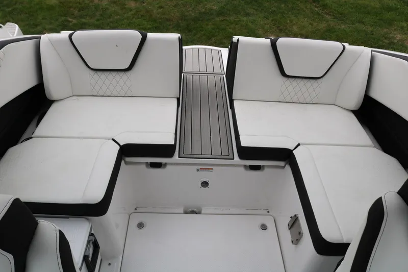 Slide: The Image of 2025 Yamaha Boats 222SE interior seating with white upholstery and black accents. - 16