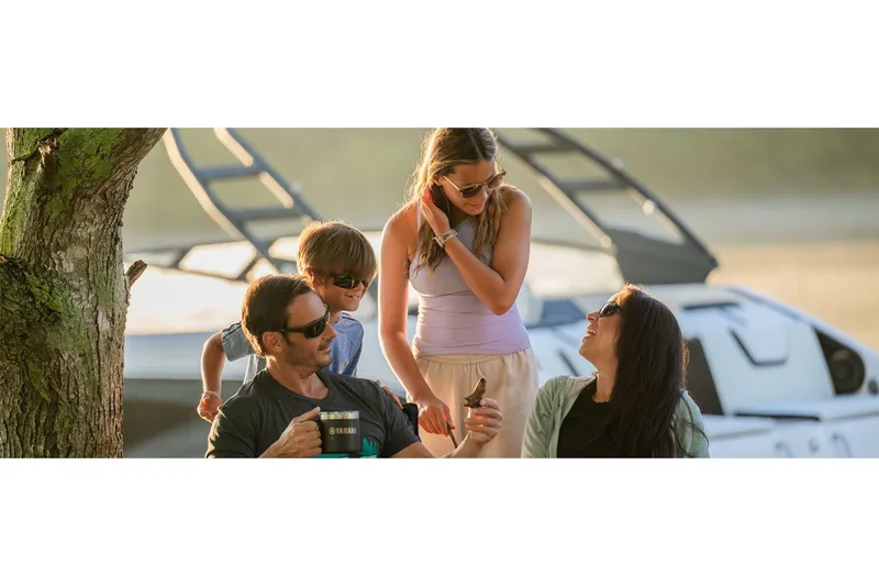 Slide: The Image of Family enjoying time near a 2025 Yamaha Boats 222SE, with a relaxed outdoor setting. - 38