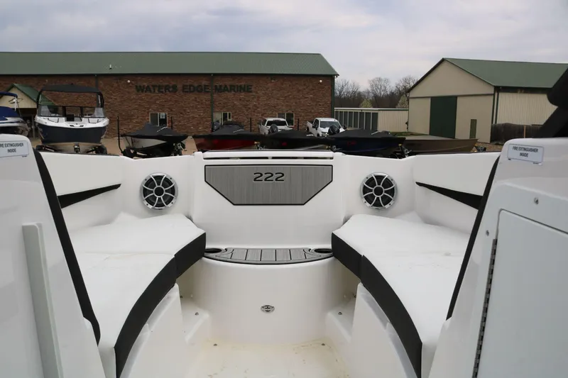 Slide: The Image of 2025 Yamaha Boats 222SE interior with seating and speakers at Waters Edge Marine. - 6