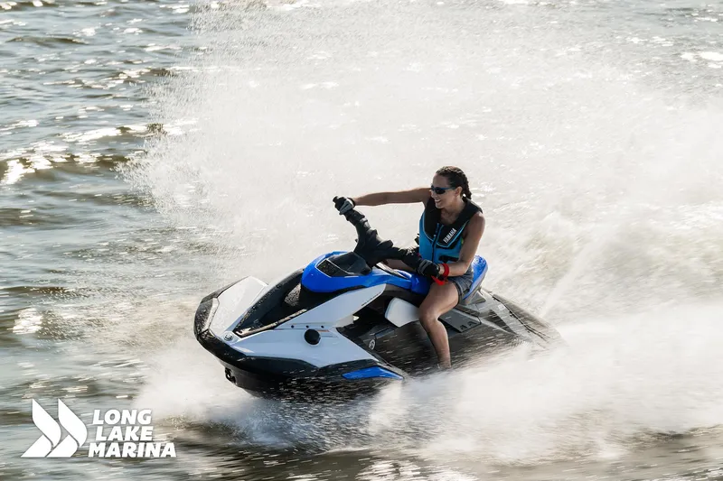 Slide: The Image of 2025 Yamaha Boats Black/Space Blue jet ski speeding on water, Long Lake Marina. - 3