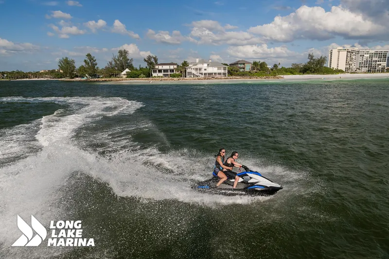 Slide: The Image of 2025 Yamaha Boats Black/Space Blue jet ski on water near Long Lake Marina. - 4