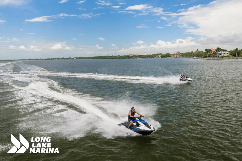 Slide: The Image of 2025 Yamaha Boats Black/Space Blue jet skis on a lake, Long Lake Marina logo visible. - 6