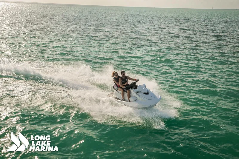 Slide: The Image of 2025 Yamaha VX Cruiser jet ski on open water, two riders enjoying a sunny day. - 6