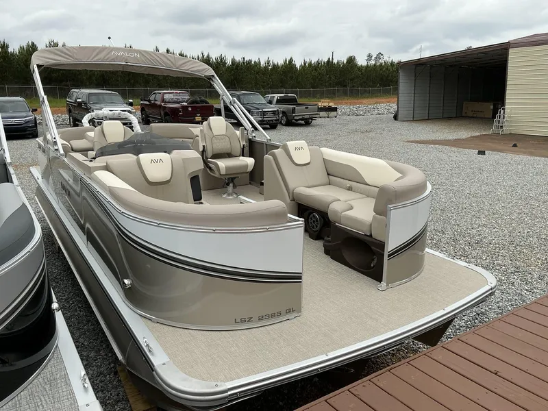 Slide: The Image of 2025 Avalon LSZ 23 Quad Lounger pontoon boat with beige seating and canopy. - 14
