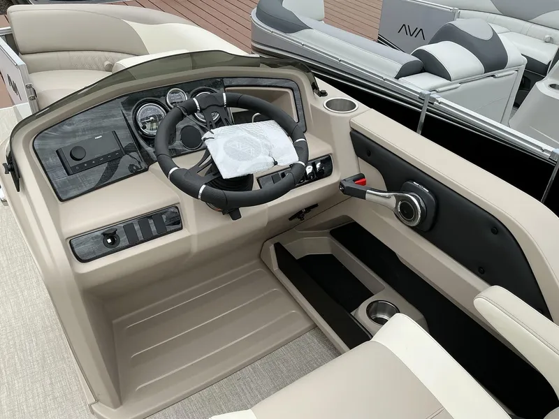 Slide: The Image of 2025 Avalon LSZ 23 Quad Lounger boat interior with steering wheel and control panel. - 3